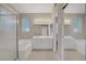 Well-lit bathroom featuring double sinks, a large mirror, a separate shower and soaking tub at 1812 Relate Ct, Las Vegas, NV 89117