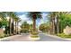 Elegant community entrance with palm trees and well-manicured landscaping at 1812 Relate Ct, Las Vegas, NV 89117