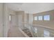 Bright upper hallway with glass railing overlooking the entry and decorative windows at 1812 Relate Ct, Las Vegas, NV 89117