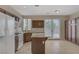 Spacious kitchen with granite counters, brown cabinets, stainless steel appliances, and tile flooring at 1812 Relate Ct, Las Vegas, NV 89117