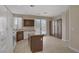 Well-lit kitchen with granite counters, brown cabinets, stainless appliances, and tile flooring at 1812 Relate Ct, Las Vegas, NV 89117