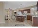 Staged kitchen featuring granite counters, tile floors, and open access to an adjacent living area at 1812 Relate Ct, Las Vegas, NV 89117