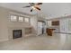 Open-concept living area with a fireplace, tile flooring, and kitchen with island and appliances at 1812 Relate Ct, Las Vegas, NV 89117