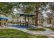 Community playground with slides, climbing structures, and shaded seating at 1812 Relate Ct, Las Vegas, NV 89117