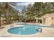 Community pool area with comfortable lounge chairs and a covered patio at 1812 Relate Ct, Las Vegas, NV 89117