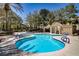 Sparkling community pool with ample lounge chairs, poolside seating, and mature landscaping at 1812 Relate Ct, Las Vegas, NV 89117