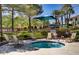 Relaxing community spa next to mature landscaping, lounge seating and playground at 1812 Relate Ct, Las Vegas, NV 89117