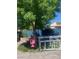 A lush backyard featuring a mature shade tree with a swing, brick patio, and well-kept landscaping at 1841 Skywood Way, Las Vegas, NV 89142