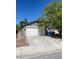 A single-story home with a large driveway and a white garage door at 1841 Skywood Way, Las Vegas, NV 89142