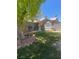 The front of the home has a well-maintained lawn and flowerbeds at 1841 Skywood Way, Las Vegas, NV 89142