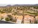 Expansive aerial shot of a charming residential area with golf course, set against a backdrop of scenic mountains at 1933 Davina St, Henderson, NV 89074