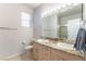 Bathroom with dual sinks, granite countertops, and a large mirror at 1933 Davina St, Henderson, NV 89074