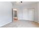Bedroom with neutral carpet, closet, and entry to adjacent living area at 1933 Davina St, Henderson, NV 89074