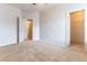 Spacious bedroom with neutral carpet, walk-in closet, and adjoining bath entry at 1933 Davina St, Henderson, NV 89074