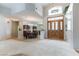 Inviting foyer with tile flooring, and grand chandelier, leading into the formal dining room at 1933 Davina St, Henderson, NV 89074