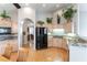 Beautiful kitchen features granite countertops, wood cabinets, and modern black appliances at 1933 Davina St, Henderson, NV 89074
