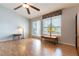 Bright and airy living area featuring wood floors, a ceiling fan, and large windows at 1933 Davina St, Henderson, NV 89074