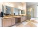 Luxury primary bathroom features a double sink vanity, a walk-in shower, and a soaking tub at 1933 Davina St, Henderson, NV 89074