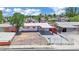 Aerial view of a single-story home featuring a carport, fresh exterior paint, and a secure gated front yard at 2016 Linden Ave, Las Vegas, NV 89101