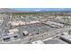 Aerial view of a commercial center with diverse businesses, a spacious parking lot, and distant mountains at 2016 Linden Ave, Las Vegas, NV 89101