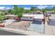 Aerial view of a single-story home featuring a carport, fresh exterior paint, and a secure gated front yard at 2016 Linden Ave, Las Vegas, NV 89101