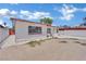 A rear view of a white house with a large backyard showcasing potential for landscaping and customization at 2016 Linden Ave, Las Vegas, NV 89101