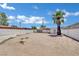 Large backyard offering ample space and potential, featuring mature tree, shed, and fence at 2016 Linden Ave, Las Vegas, NV 89101