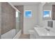 Bathroom with a glass-enclosed tub, tile accents, and bright natural light at 2016 Linden Ave, Las Vegas, NV 89101