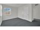 Bright bedroom with natural light, gray carpet, and painted brick accent wall at 2016 Linden Ave, Las Vegas, NV 89101