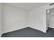 Clean bedroom with neutral walls and carpet near the bathroom entry at 2016 Linden Ave, Las Vegas, NV 89101
