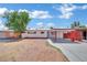 Charming single-story home featuring a carport, fresh exterior paint, and a secure gated front yard at 2016 Linden Ave, Las Vegas, NV 89101