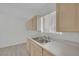 Bright kitchen featuring a double sink, window, and neutral-toned cabinets at 2016 Linden Ave, Las Vegas, NV 89101