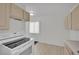 Bright kitchen showcasing white cabinets, appliances, and flooring, with a window for natural light at 2016 Linden Ave, Las Vegas, NV 89101