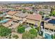 Expansive backyard featuring a pool, patio, lush greenery, and desert landscaping at 2189 De Narvik Dr, Henderson, NV 89044