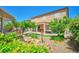 Private backyard featuring a charming water feature, patio seating, and mature landscaping at 2189 De Narvik Dr, Henderson, NV 89044