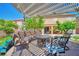 Inviting backyard patio with comfortable seating under a pergola, ideal for outdoor gatherings at 2189 De Narvik Dr, Henderson, NV 89044