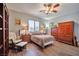 Comfortable bedroom with wood floors, ceiling fan, and ample natural light through a large window at 2189 De Narvik Dr, Henderson, NV 89044