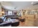Spacious living room featuring a large leather couch and lots of art at 2189 De Narvik Dr, Henderson, NV 89044
