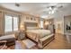 Bright and airy main bedroom featuring a large bed, wood floors, and tasteful furnishings at 2189 De Narvik Dr, Henderson, NV 89044