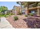 Low angle shows well-maintained exterior with lush greenery and gravel landscaping at 2300 E Silverado Ranch Blvd # 1165, Las Vegas, NV 89183