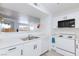 Open kitchen featuring white cabinets, updated appliances, and view to the living space at 2300 E Silverado Ranch Blvd # 1165, Las Vegas, NV 89183