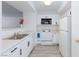 Clean and functional kitchen with white appliances, sleek countertops, and ample cabinet space at 2300 E Silverado Ranch Blvd # 1165, Las Vegas, NV 89183