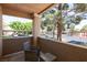 This cozy covered patio offers outdoor living space with seating and views of the parking area at 2300 E Silverado Ranch Blvd # 1165, Las Vegas, NV 89183