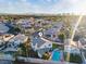 Sunlit aerial view of the home and neighborhood, emphasizing the pool, landscape, and serene location at 2639 Regency Cove Ct, Las Vegas, NV 89121