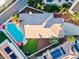Aerial view of the property with a large pool, lush lawn, and landscaping showcasing outdoor features at 2639 Regency Cove Ct, Las Vegas, NV 89121