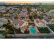 Neighborhood aerial view showcasing a backyard pool, patio umbrellas, and mountain views in the distance at 2639 Regency Cove Ct, Las Vegas, NV 89121