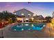 Backyard oasis featuring a sparkling pool, manicured landscaping, and patio furniture at 2639 Regency Cove Ct, Las Vegas, NV 89121