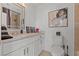 Modern bathroom with a granite countertop, white cabinetry, and tile floors at 2639 Regency Cove Ct, Las Vegas, NV 89121
