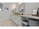 Bright bathroom featuring double sinks, modern vanity, and vanity mirror at 2639 Regency Cove Ct, Las Vegas, NV 89121