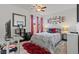 Comfortable bedroom with a ceiling fan, window views, and stylish decor at 2639 Regency Cove Ct, Las Vegas, NV 89121
